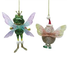 two glass christmas ornaments hanging from chains on a white background, one with a green frog and the other wearing a santa hat