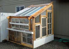 a small greenhouse built into the side of a house