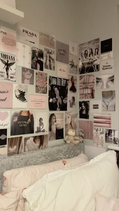 there is a bed with many pictures on the wall