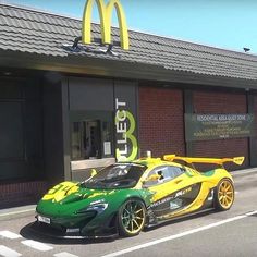 a green and yellow sports car parked in front of a mcdonalds