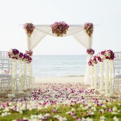 an outdoor wedding setup with white and purple flowers