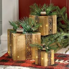 three wooden boxes sitting on top of a rug next to a christmas tree with lights