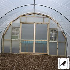 the inside of a building with a bird in it's window and dirt on the ground