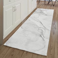 a large white rug in the middle of a kitchen