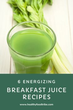 a glass filled with green juice next to celery