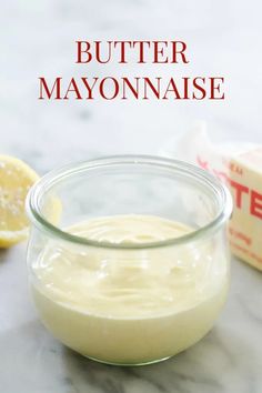 butter mayonnaise in a glass bowl next to sliced lemons