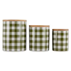 three green and white checkered cups with wooden lids