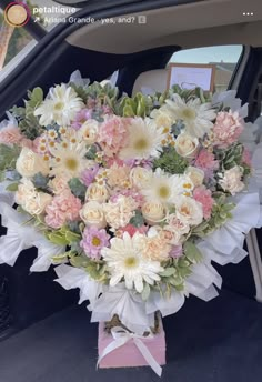 a bouquet of flowers sitting in the back of a car