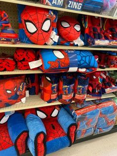 there are many spiderman toys on display in the store