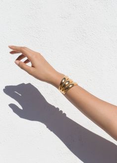 A thick cuff with a luxury, '70s feeling, but still comfortable to wear. Available in a double and single size for those who like to make a more subtle statement. Approximately 1.75'' Width, 2'' Height Available in 14K Gold Plate over Brass and Sterling Silver. Handmade in NYC In stock items ship in 1 to 4 days. Luxury Gold Open Cuff Bangle, Modern Yellow Gold Wide Band Bracelet, Timeless Open Cuff Bangle With Polished Finish, Timeless Gold Open Cuff Bracelet, Luxury Wide Band Bangle, Formal Yellow Gold Cuff Bracelet, Classic Gold Open Cuff Bracelet, Luxury Wide Band Gold Bangle, Luxury Gold Wide Band Bangle