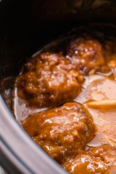 the meatballs are being cooked in the crock pot with sauce on top and ice