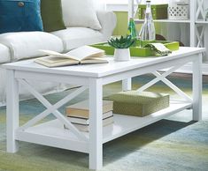 a white coffee table with books on it