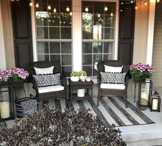 the front porch is decorated with wicker chairs and lanterns