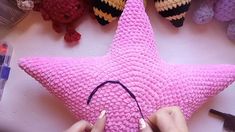 someone is making a crocheted star decoration