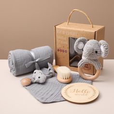 an elephant toy sitting next to a baby's gift box