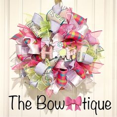 the bowtiquee is hanging on the door with its name written in large letters