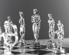 silver figurines on a chess board in black and white