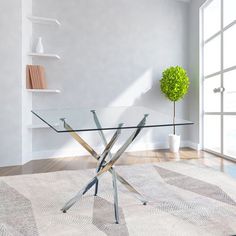 a glass table sitting on top of a wooden floor next to a white vase with a green plant