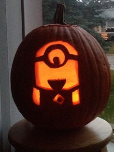 a pumpkin carved to look like an evil minion