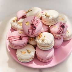 a pink plate topped with lots of macaroons