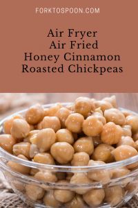 a glass bowl filled with honey cinnamon roasted chickpeas on top of a table