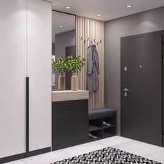 a bathroom with a black and white rug next to a gray wall mounted coat rack