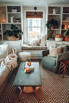 a living room filled with furniture and lots of plants in the window sills