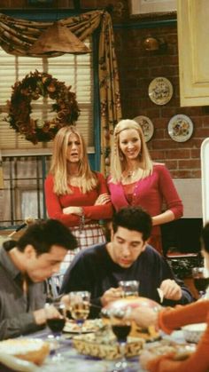 three women and two men sitting at a dinner table