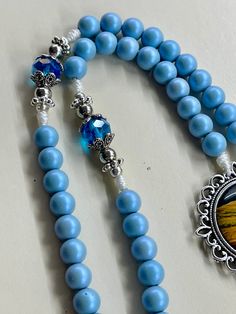 Spiritual Colorful Beads Rosary As Gift, Spiritual Rosary With Colorful Beads As Gift, Blue Crucifix Necklace For Spiritual Wear, Blue Crucifix Necklace For Spiritual Purposes, Blue Beaded Rosary As A Gift, Spiritual Rosary With Large Beads As Gift, Handmade Turquoise Rosary Bracelet As Gift, Blue 108 Beads Spiritual Rosary, Spiritual Blue Rosary With 108 Beads