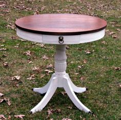 a white table sitting on top of a lush green field