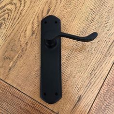 a black door handle on a wooden floor