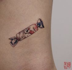 a small tattoo on the side of a woman's stomach