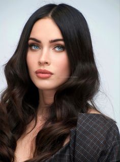 a woman with long dark hair and blue eyes