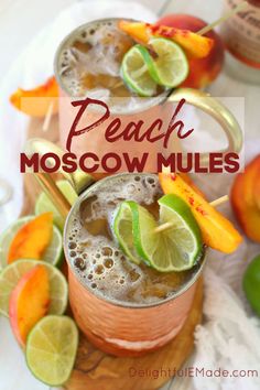 two glasses filled with peach moscow mules on top of a cutting board