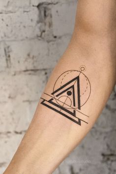 a person with a tattoo on their arm that has an image of a triangle in it