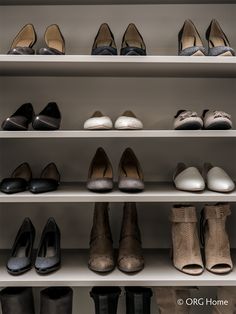 many pairs of shoes are lined up on shelves