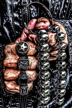 a man with his hand in the air holding several different bracelets