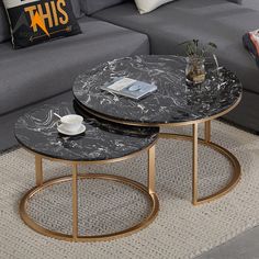 two tables sitting on top of each other in front of a couch