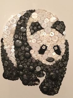 an art piece made out of buttons on a wall