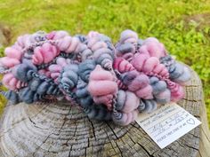 a pile of wool sitting on top of a wooden stump