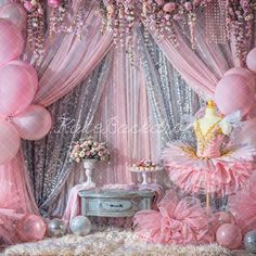 a pink and silver birthday party with balloons, cake, tablecloths and decorations