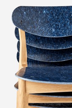 a stack of blue skateboards sitting next to each other on top of a wooden chair