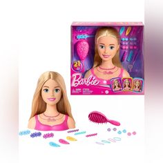 the barbie doll is next to her hairbrush and comb