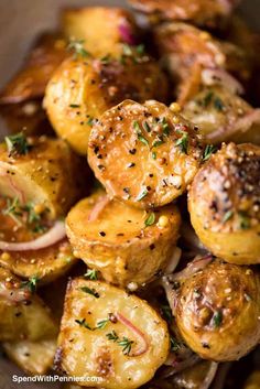 roasted potatoes with onions and herbs in a bowl