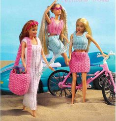 three barbie dolls standing in front of a car on the beach with a pink bicycle