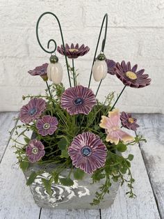 an arrangement of flowers in a vase on a wooden table