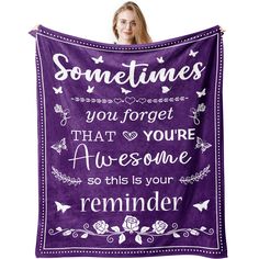 a woman holding up a purple blanket that says sometimes you forget that you're awesome, so this is your reminder