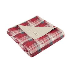 the red and white plaid blanket is folded on top of it's pillow case