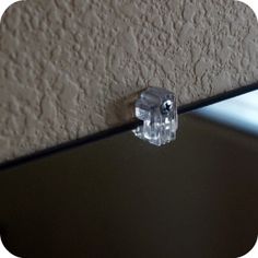 an object that is sitting on top of a glass table in front of a wall