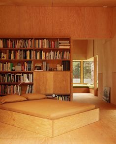 a bedroom with bookshelves and a bed in it